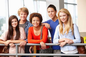 group of multi-racial teens indoors at school
